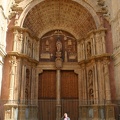 Olga dwarfed by the cathedral doors
