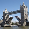 An old sailing barge passing under Tower Bridge