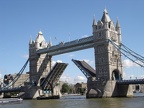 An old sailing barge passing under Tower Bridge