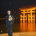 Micha in front of the lit-up torii gate.